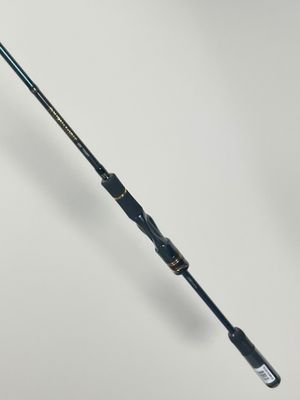 a close up of a fishing rod on a white surface