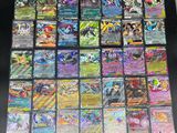 the collection of pokemon cards are displayed on a table