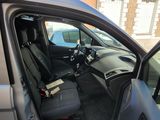 the interior of a car with the door open and the driver ' s seat down