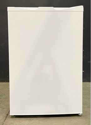 an image of a white refrigerator sitting on a concrete floor