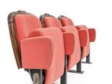 a row of red seats in an empty theater