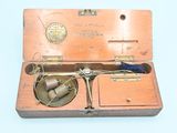 a small box with a pair of scissors in it