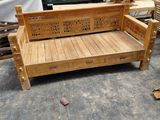 a wooden bench that is sitting in the middle of a room