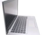 a laptop computer that is open on a white surface