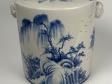 a blue and white vase with a tree on it