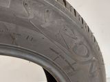 a close up of a tire on a white wall with a white background