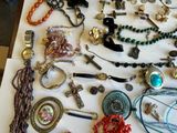 many different types of jewelry displayed on a table