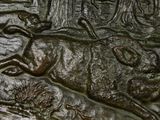 a close up of a sculpture of a boar in the woods