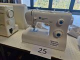 a white sewing machine on a table with a price tag