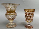 two glass vases sitting next to each other on a table