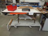 a workbench in a workshop with a lot of tools on it