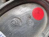 a close up of a metal object with a red sticker on it