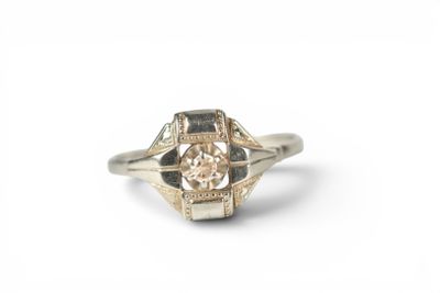 a close up of a ring with a diamond in it