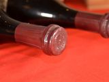 two bottles of wine that are sitting on a table