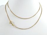 a close up of a gold necklace on a mannequin mannequin