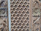 an image of a close up of a wooden door with carvings on it