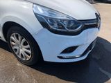 the front end of a white car parked in a parking lot