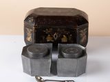 a small box with a spoon and a spoon rest on a table
