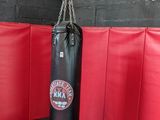 a man standing next to a punching bag in a gym