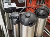 three kegs that are sitting on a shelf in a store