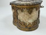 a gold and marble box with a bird on top