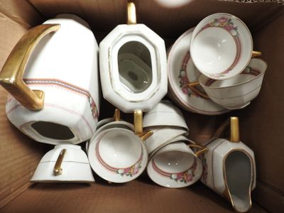 a box with a bunch of tea pots and cups in it