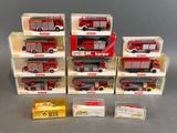 six red and white firetrucks are in boxes on a gray surface