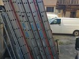 a truck that is parked next to a pile of ladders