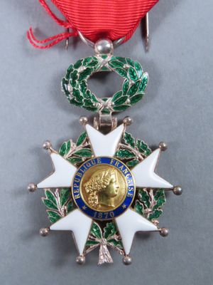 an image of a medal with a red ribbon around it