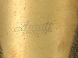 a close up of a gold vase with a name on it