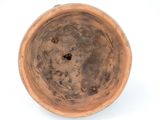 a brown vase that is sitting on a white surface