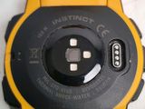 a close up of a yellow and black watch on a table