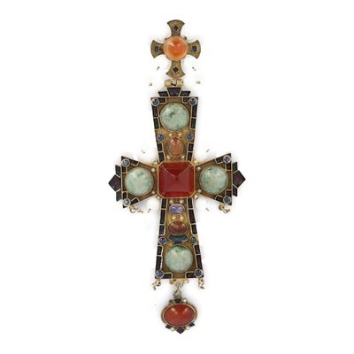 une image représentant une croix en verre, avec une pierre rouge et une pierre verte au centre
