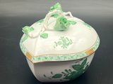 an image of a green and white bowl with a lid on a table