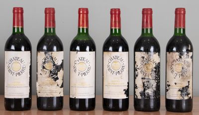 six bottles of wine are lined up on a wooden table
