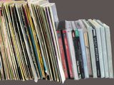 a lot of books that are stacked on top of each other