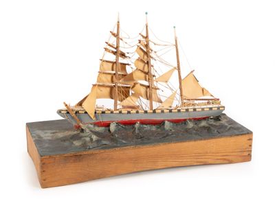 a wooden model of a ship on display on a table
