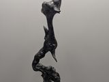 an image of a sculpture of a bird sitting on top of a rock