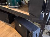 a shelf that has a bunch of musical equipment on it