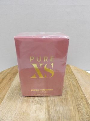 a pink box of perfume sitting on top of a wooden table
