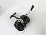 two fishing reels that are sitting on a table