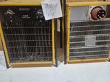 two electric heaters sitting next to each other on the floor
