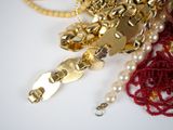 a bunch of jewelry on a table with a white background