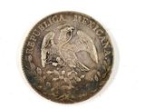 an old coin with a bird on it sitting on a white surface