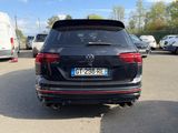 the rear end of a black volkswagen suv parked in a parking lot