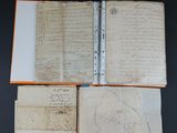 an open book with a pencil and some papers on a table