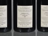 three bottles of wine sitting on top of a table next to each other