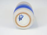 a blue and white vase on a white surface