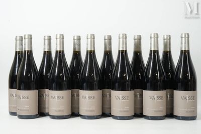 six bottles of wine are lined up in a row on a white surface