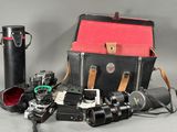 many different types of cameras and a case on the table
